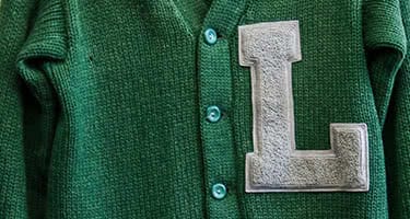 An old green sweater with a grey L