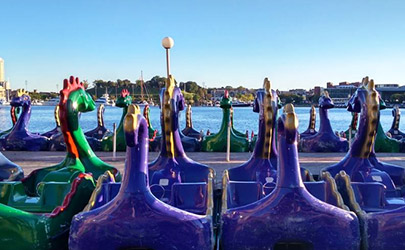 Rows of paddle boats shaped like dragons overlook the Inner Harbor of downtown Baltimore