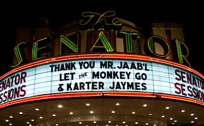 Theatre marquee displaying various messages outside the Senator Theater in Belvedere Square, Baltimore